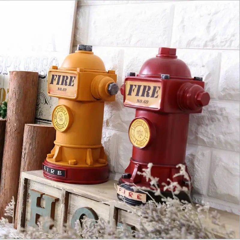Two vintage-style red and yellow hydrant piggy banks with fire label and no 69 for living room decor