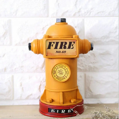 A vibrant yellow and red hydrant piggy bank with black caps and embossed fire branding for living room decor