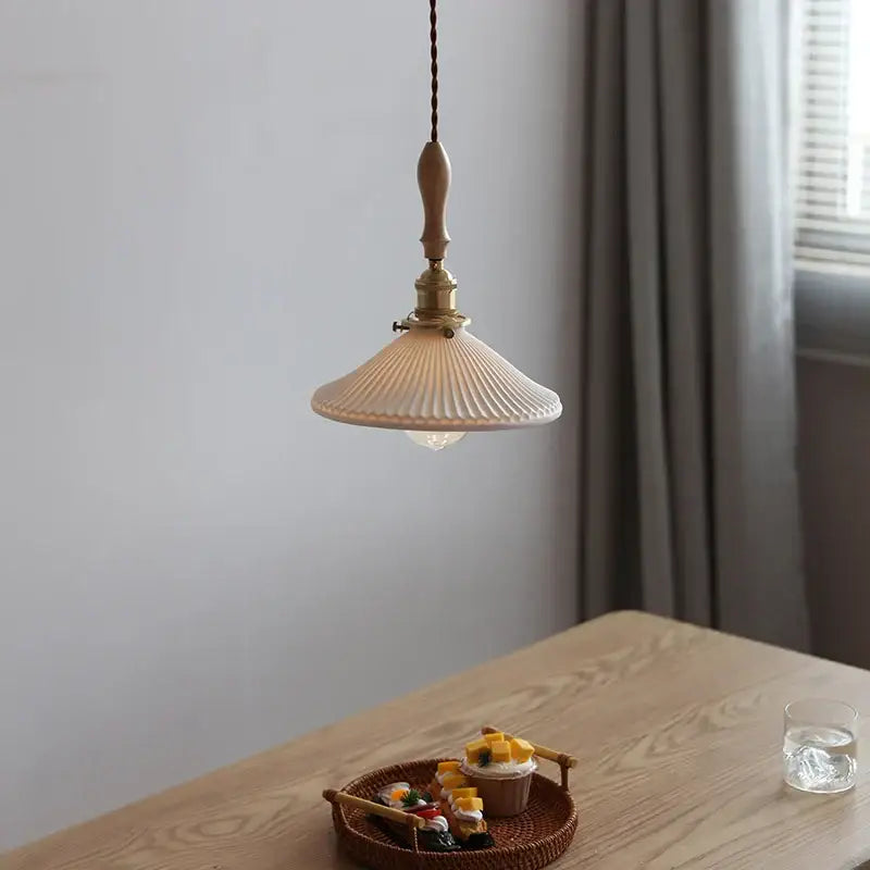 Cream-colored ribbed glass pendant light with brass fixture and wooden pull chain for decorbites ceramic led pendant use