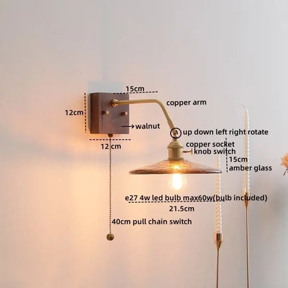 Vintage wall lamps featuring ceramic copper led with copper arm, walnut base, and amber ribbed glass shade by decorbites