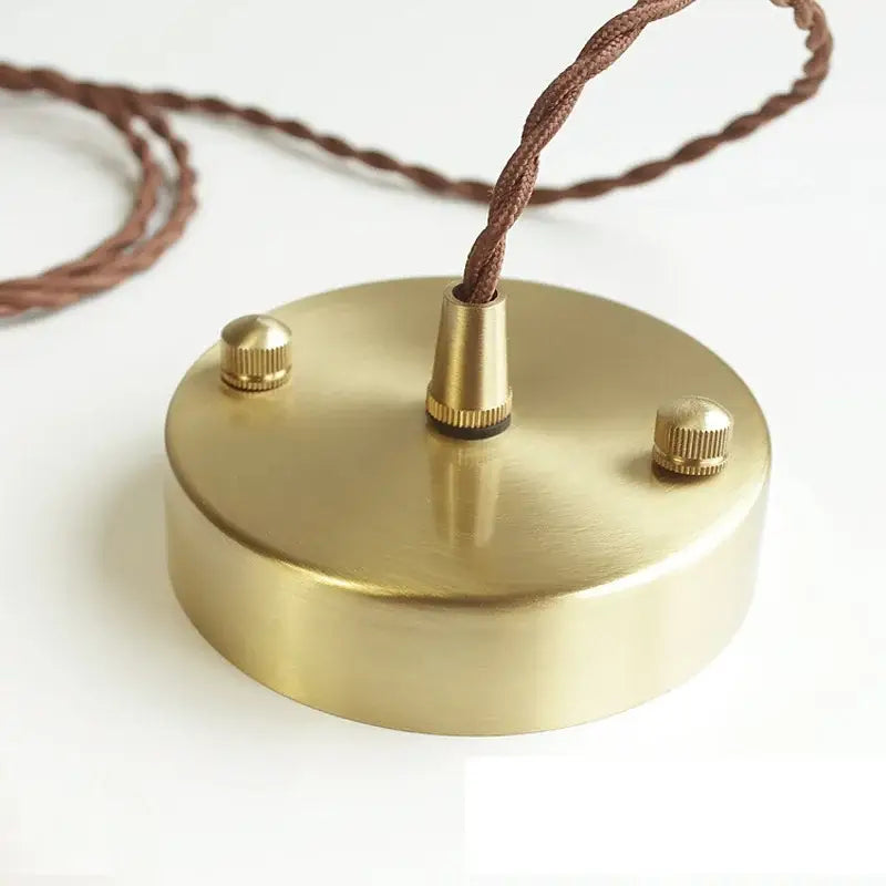 Brass-finished circular pendant light fixture with textured brown braided cord and adjustment knobs for kitchen use