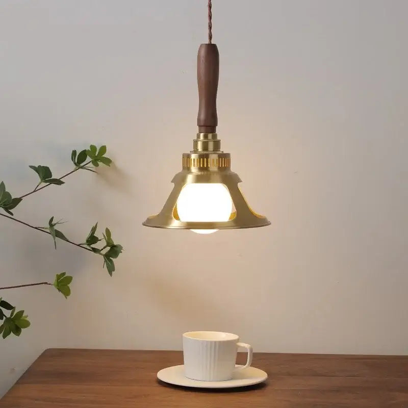 A warm brass vintage scalloped glass copper walnut led pendant light with wooden handle above a white cup