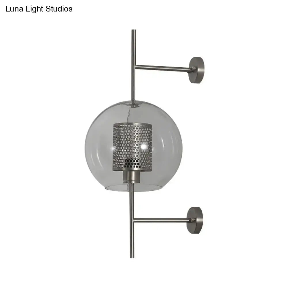 Modern vintage silver and gold clear glass sconce light with perforated metal shade and brushed nickel arms for bedroom walls