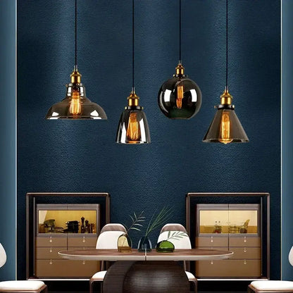 Four vintage pendant lights with brass fixtures and decorbites amber glass in smoked and glossy black finishes for dining room