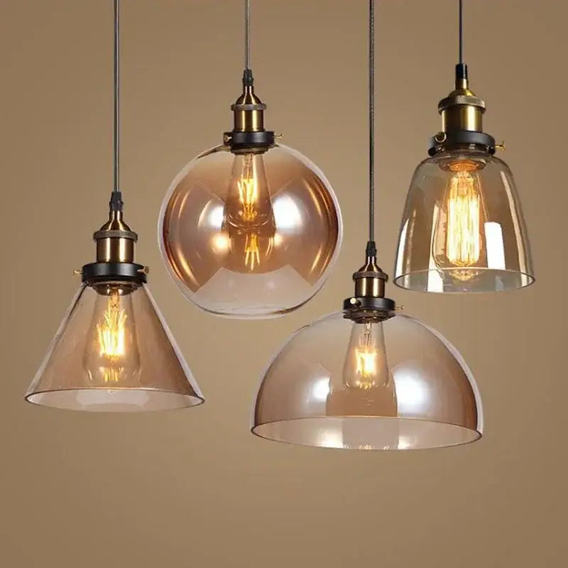 Four vintage-style pendant lights with decorbites amber glass vintage shades and brass fixtures for dining room lighting
