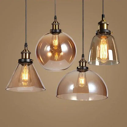 Four vintage-style pendant lights with decorbites amber glass vintage shades and brass fixtures for dining room lighting