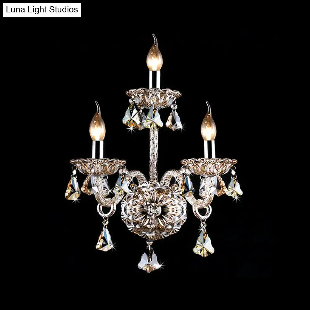 Elegant vintage style wall light featuring three-arm silver-toned metalwork with amber crystal candle accents