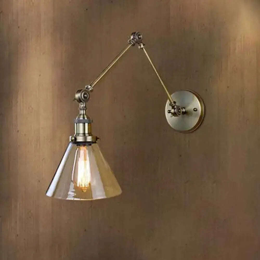Adjustable vintage style wall sconce with clear glass conical shade and antique brass finish for living room lighting