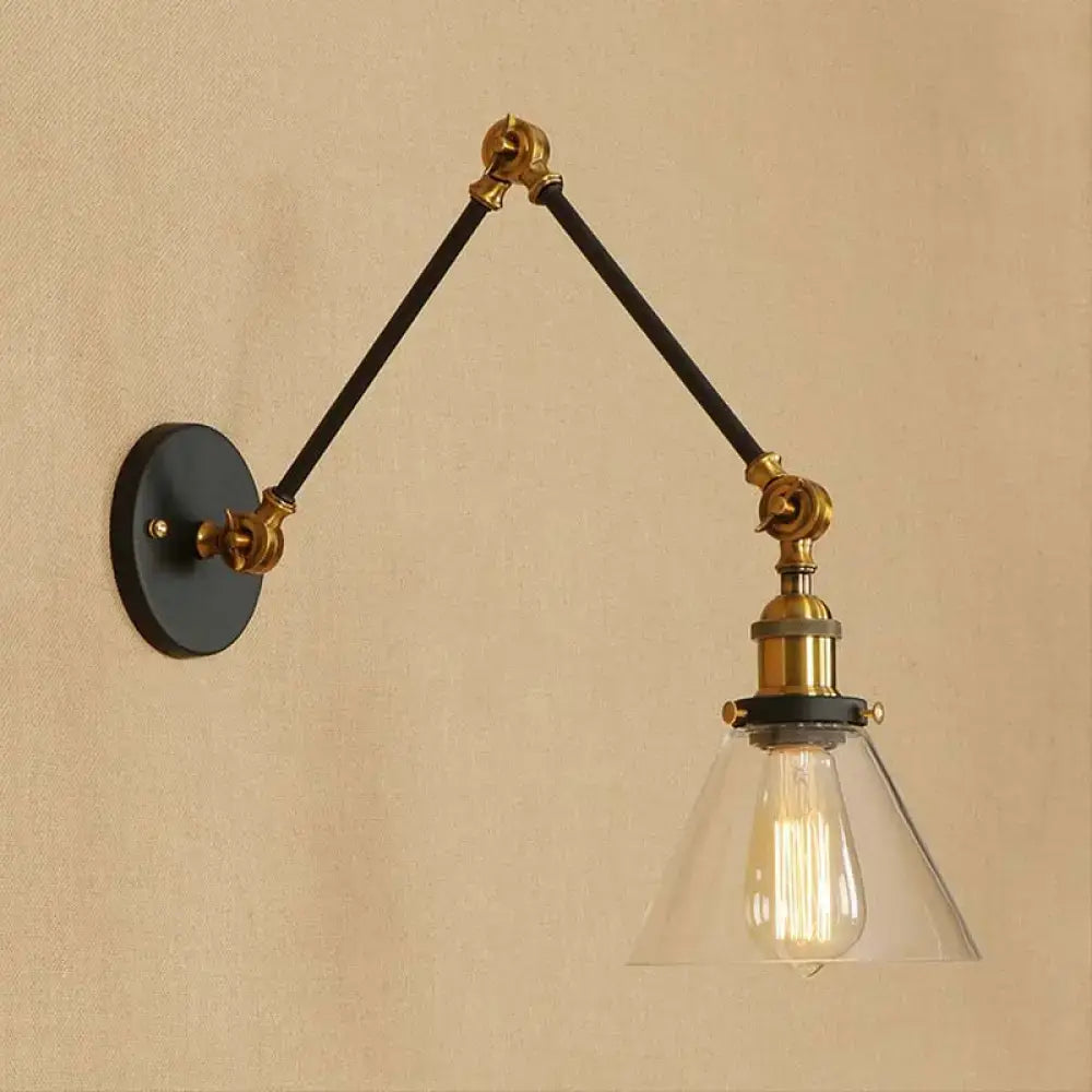 Vintage style decorbites wall sconce with satin brass hardware black articulated arms and clear glass shade with filament bulb