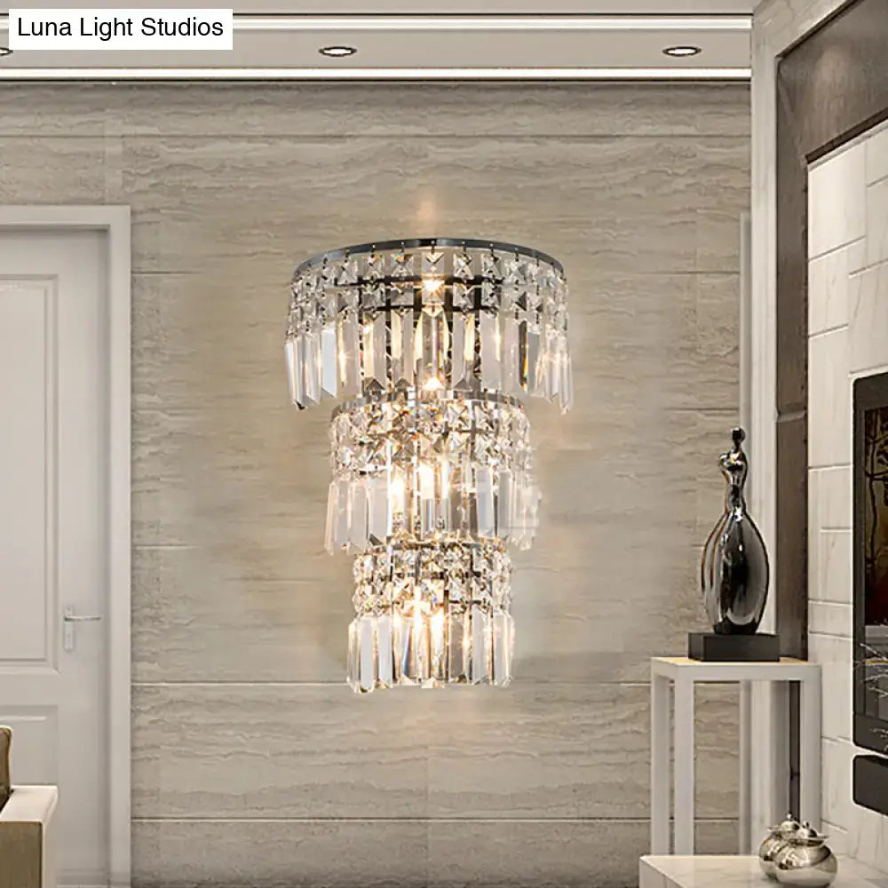 Vintage style clear crystal tiered chrome wall sconce with cascading glass prisms for elegant hallway lighting