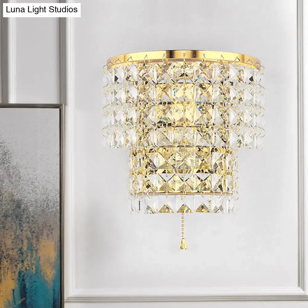 Vintage style gold finished crystal wall sconce with tiered faceted glass and matching pull chain for bedroom lighting