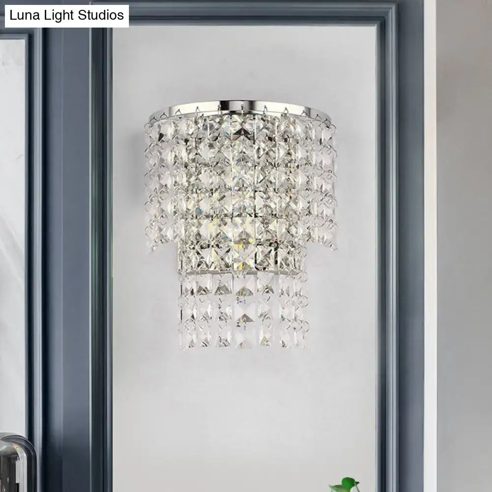 Vintage style gold and chrome crystal wall sconce with tiered faceted glass elements that refract light beautifully