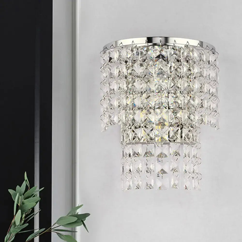 Vintage style wall sconce featuring a tiered crystal chandelier design with sleek chrome finish for bedroom lighting