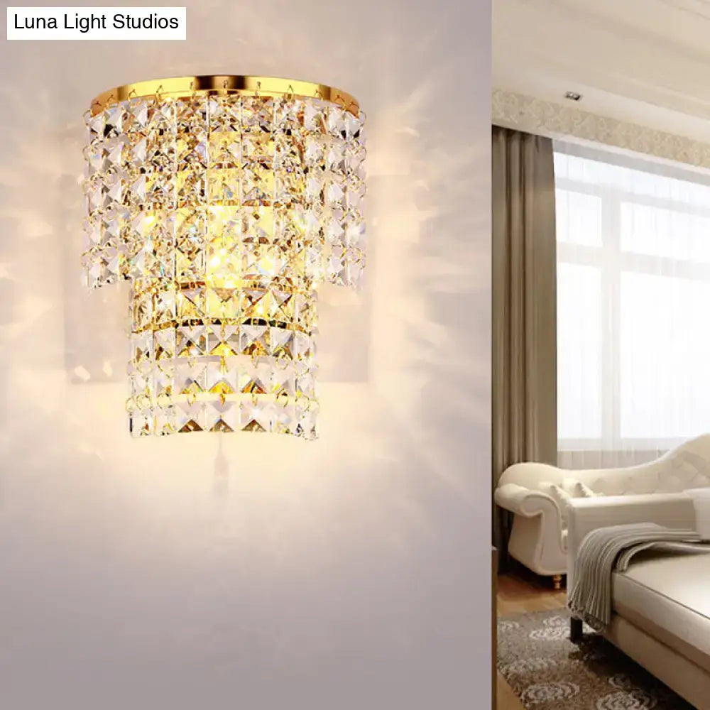 Vintage style gold-toned wall sconce with cascading clear faceted crystal tiers for bedroom lighting