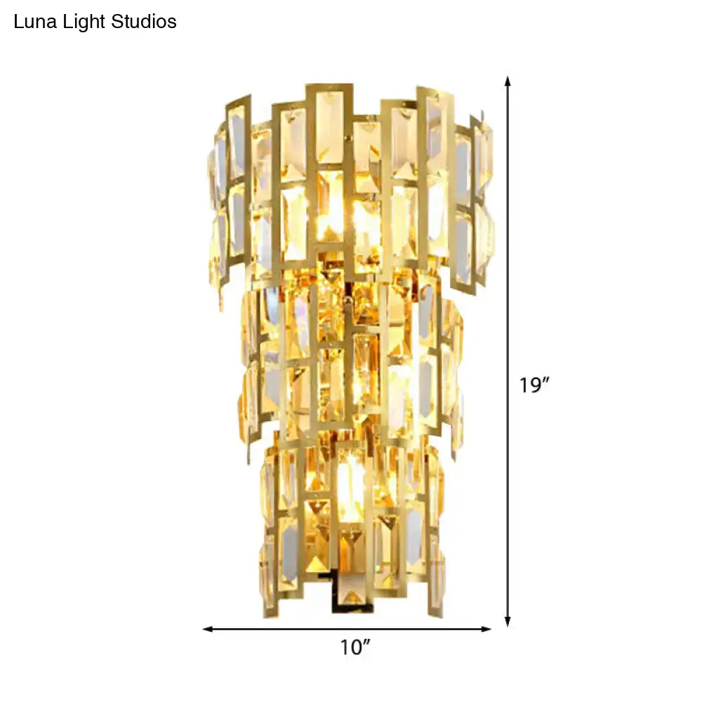 Vintage style gold tiered wall sconce with a golden rectangular crystal chandelier for elegant living room decor