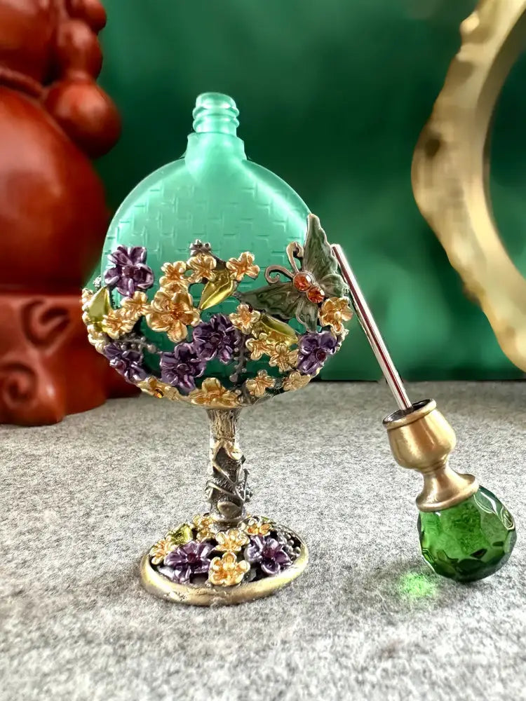 Vintage teal and purple glass perfume bottle with gold and floral embellishments for elegant bedroom decor