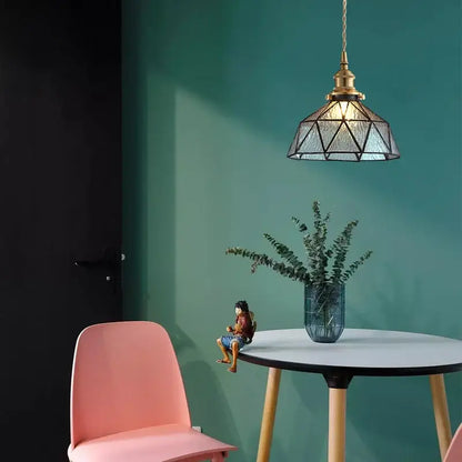 Vintage teal blue glass led pendant light with geometric glass and brass accents emitting a warm glow decorbites blue glass
