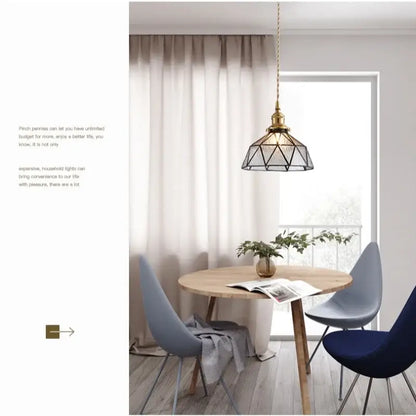 A brass-finished pendant light with a geometric cage and teal blue glass led shade for kitchen decorbites blue glass