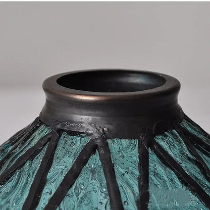 Vintage teal blue glass led pendant light with a teal and black textured vase and wide dark rim decorbites blue glass decor