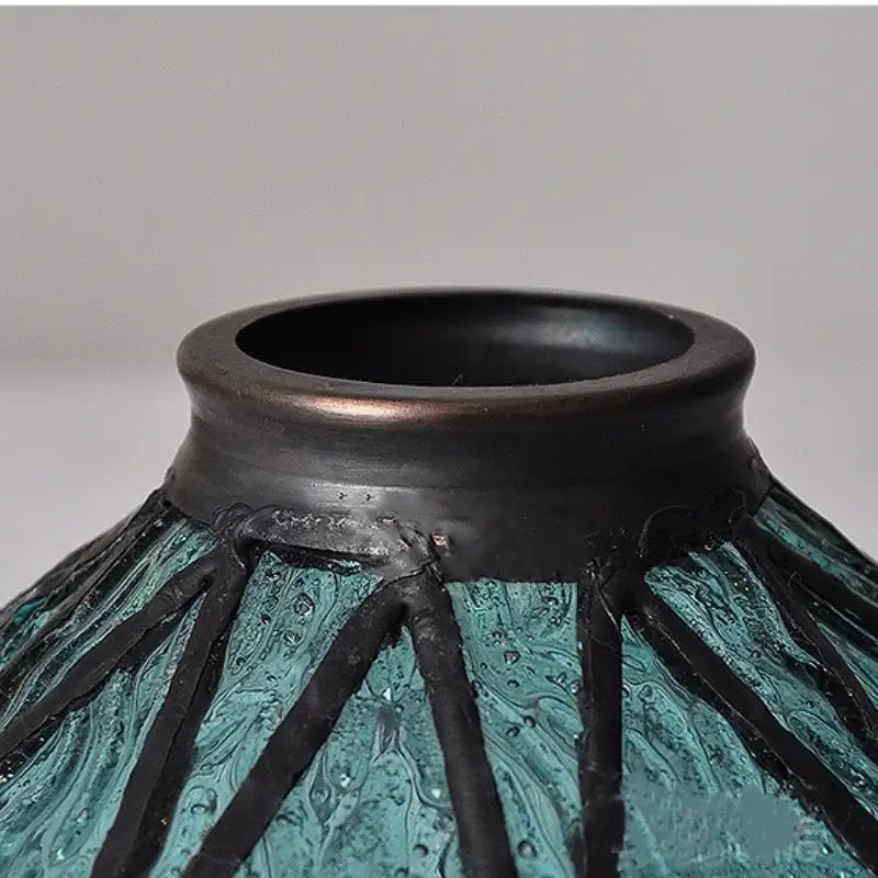 Vintage teal blue glass led pendant light with a teal and black textured vase and wide dark rim decorbites blue glass decor
