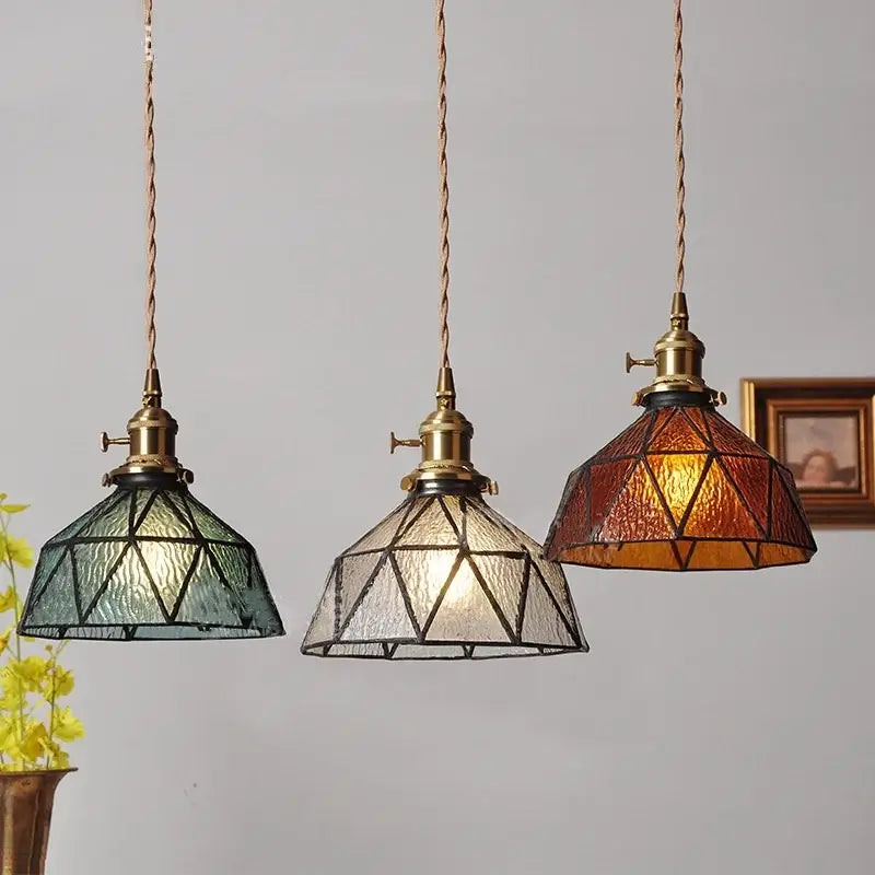 Vintage teal blue glass led pendant light featuring three brass fixtures with green, clear, and amber textured shades