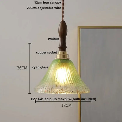 A warm glowing vintage walnut and green glass led wood pendant light with textured cyan shade and iron canopy
