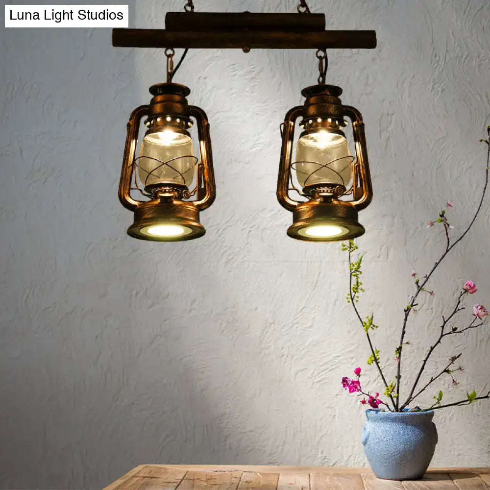 Vintage brass copper lantern island light with clear glass globes hanging from rustic wooden kitchen bar fixture