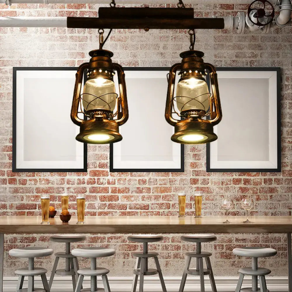 Two vintage-style brass lanterns with warm glow hang from wood beam in decorbites copper lantern island light fixture