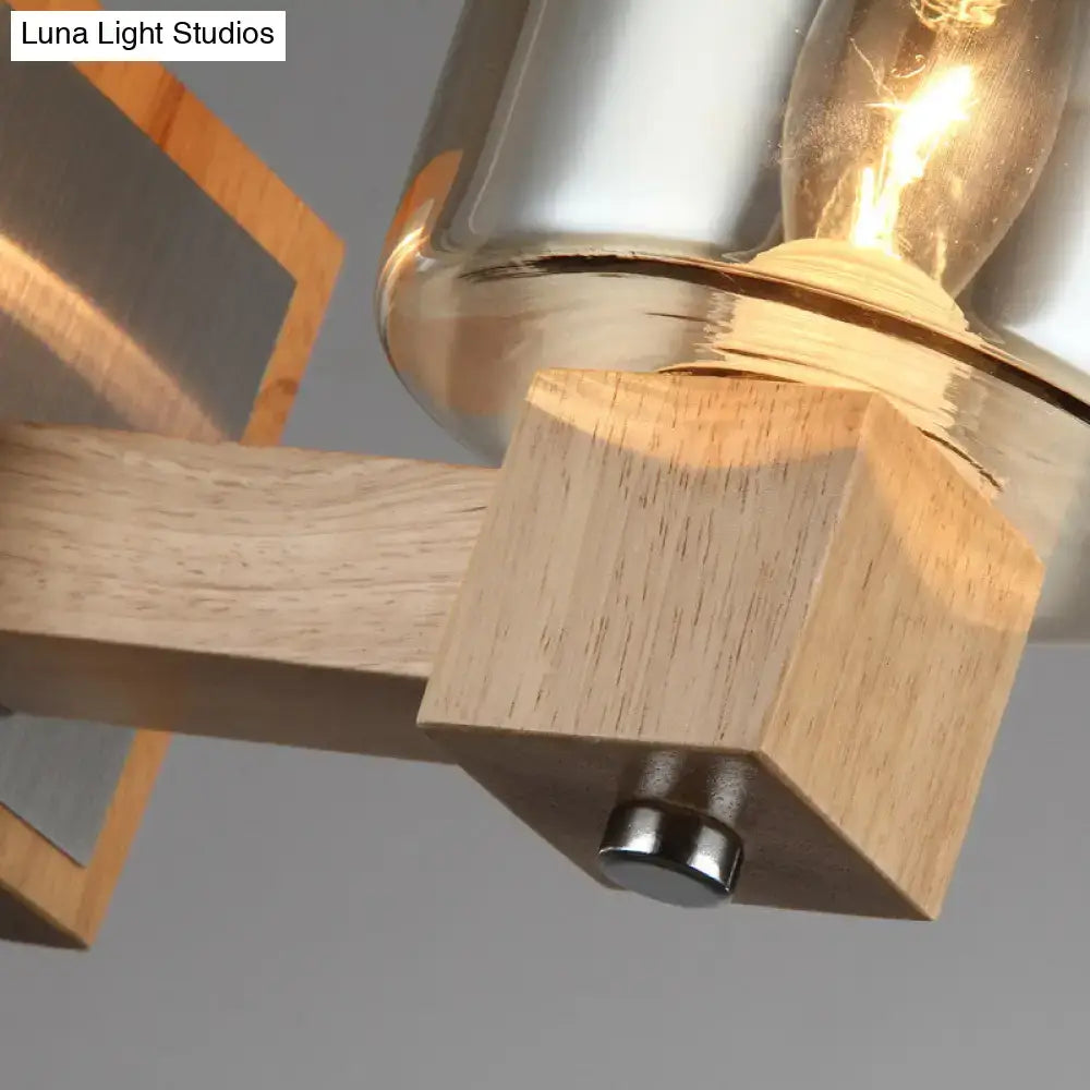 Modern wall lamp with warm wood base polished brass accents and smoke glass shade wall mount for bedroom sconce