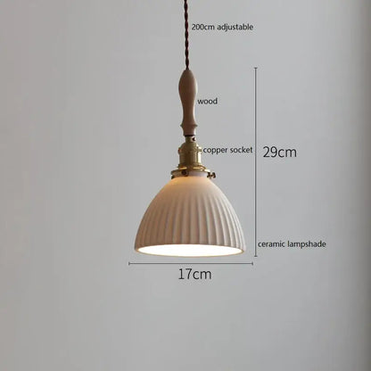 Cream-colored ceramic led pendant light with vertical ridges, wooden handle, and brass copper socket for dining room decorbites ceramic led