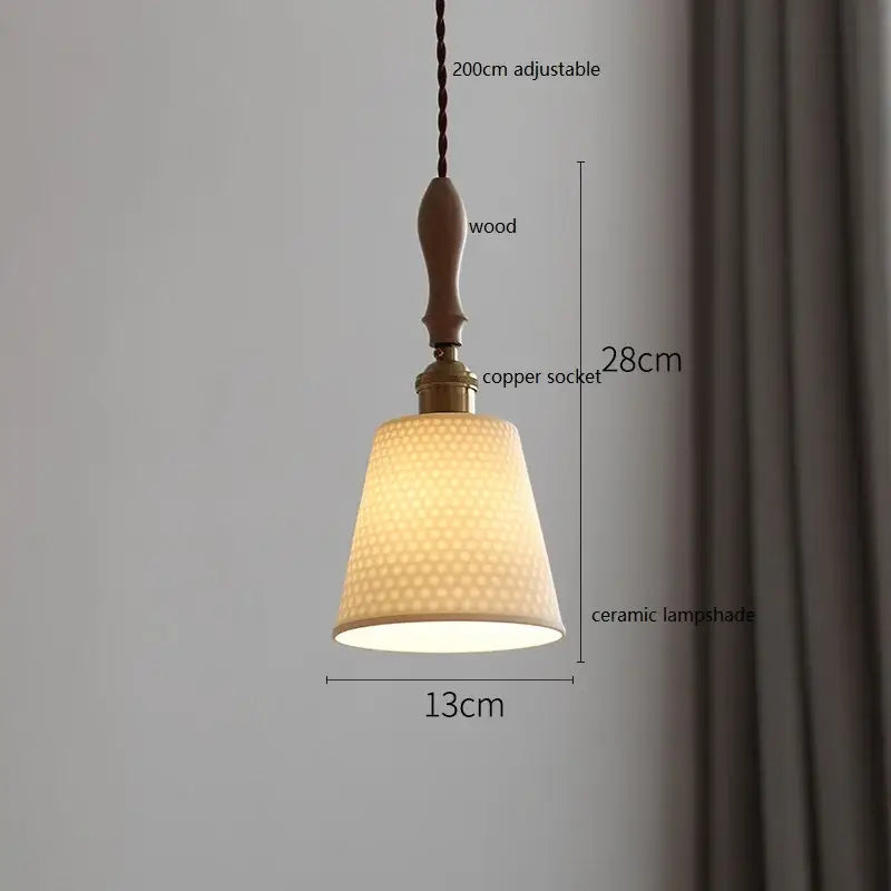 A warm-toned vintage ceramic led pendant light with a honeycomb pattern hanging from a wooden handle and copper socket