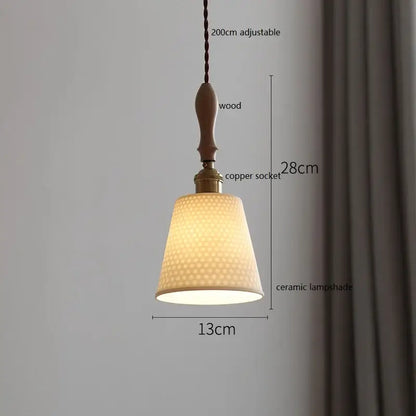 A warm-toned vintage ceramic led pendant light with a honeycomb pattern hanging from a wooden handle and copper socket