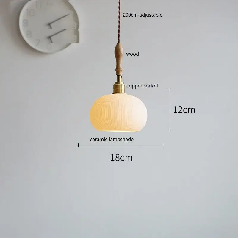 A warm-toned ceramic led pendant light with ribbed surface and wooden pendant for dining room decorbites ceramic led