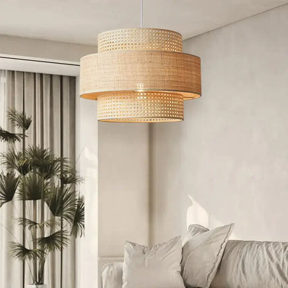Beige woven rattan wabi sabi pendant light with three tiered cylindrical sections for dining room layered shade