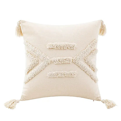 Cream-colored tufted cushion cover with off-white woven geometric patterns and matching tassels for living room use