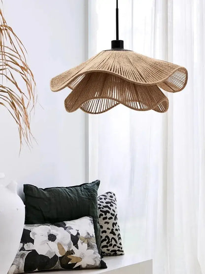 Beige woven rattan pendant light offers a fluted petal design with black metal suspension for cord pendant installation