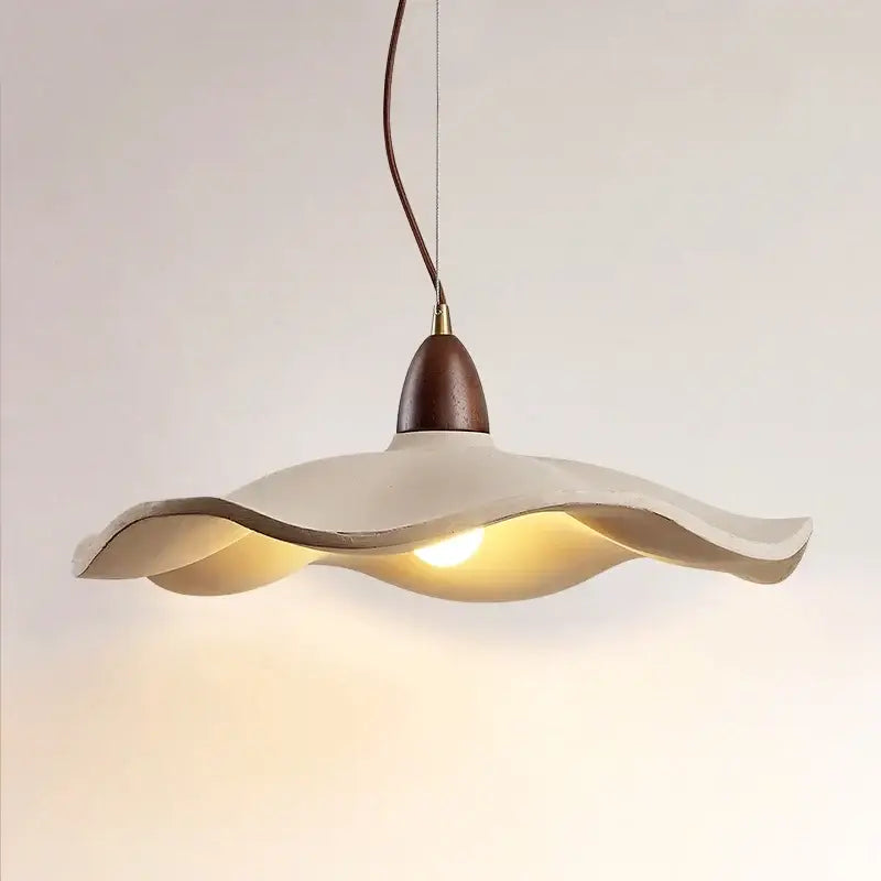 Cream-colored wavy-edged pendant light with dark wood top and brass accent made of natural wood material for dining room