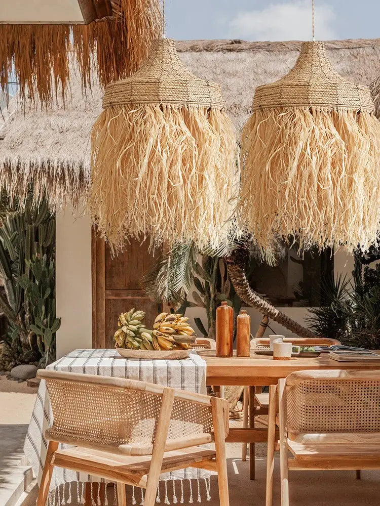 Natural woven straw pendant lamps with fringed handmade woven rattan design hang above outdoor dining area decorbites handmade woven