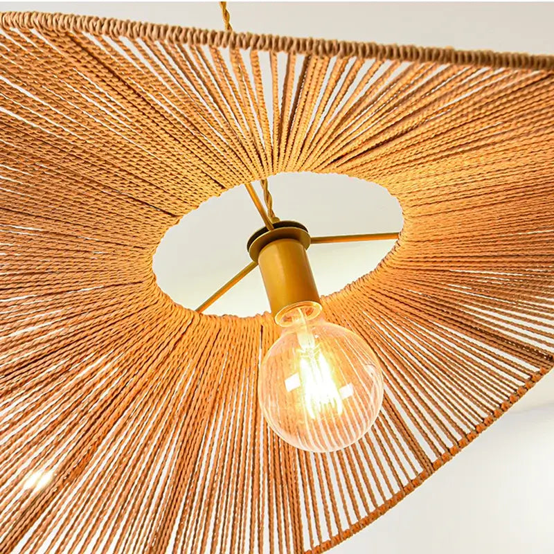 Warm-toned bamboo wabi sabi pendant lights with brass bulb holder and exposed filament for dining room lighting