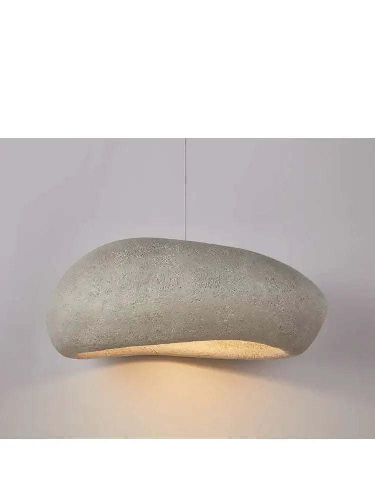 A sleek gray wabi sabi decorbites handmade polystyrene indoor pendant light with a smooth organic shape and warm glow