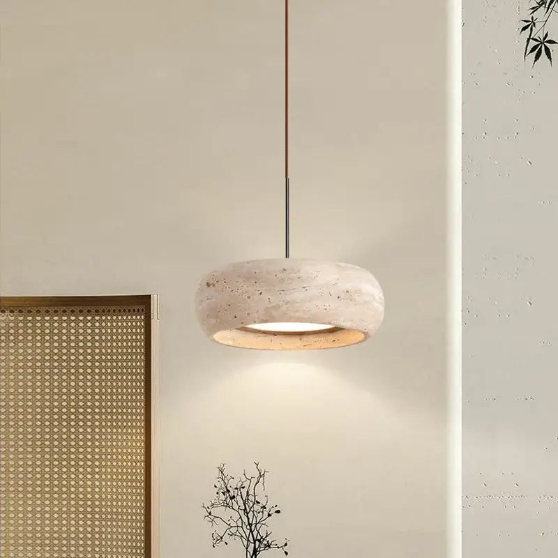 Wabi-sabi off-white stone pendant light with textured concrete shade and copper stem for dining room lighting