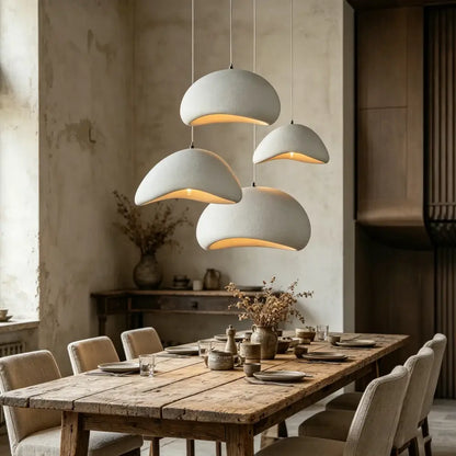 Modern white and gray high-density polystyrene pendant light with led bulb hanging above rustic dining table