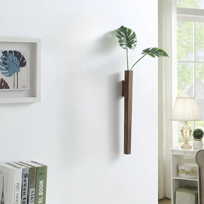Dark wood wall hanging plant holder with two green monstera leaves for bohemian home wall decoration
