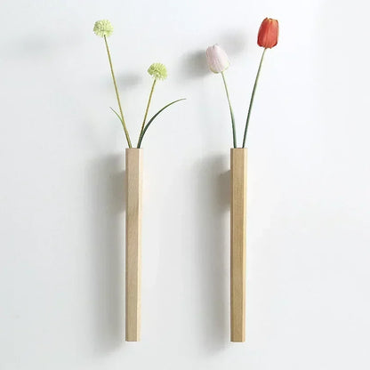 Two minimalist wooden wall hanging vases with green globe flowers and pink and red tulips for bohemian home decor