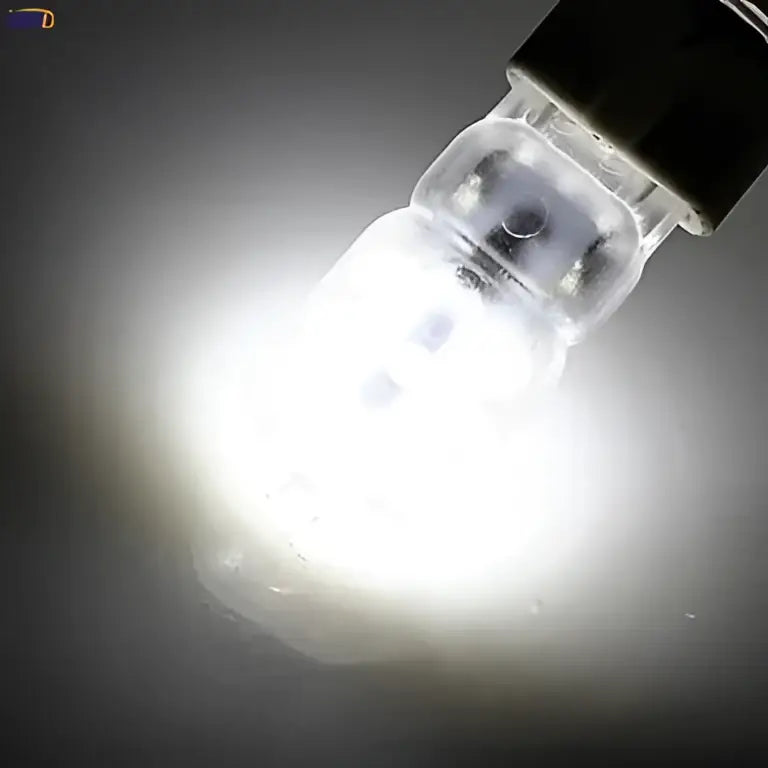A bright white DecorBites G9 LED bulb with clear glass body and black base for warm white living room light