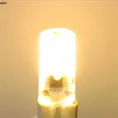 A warm white decorbites dimmable led bulb with cylindrical glass body and metallic base for living room lighting