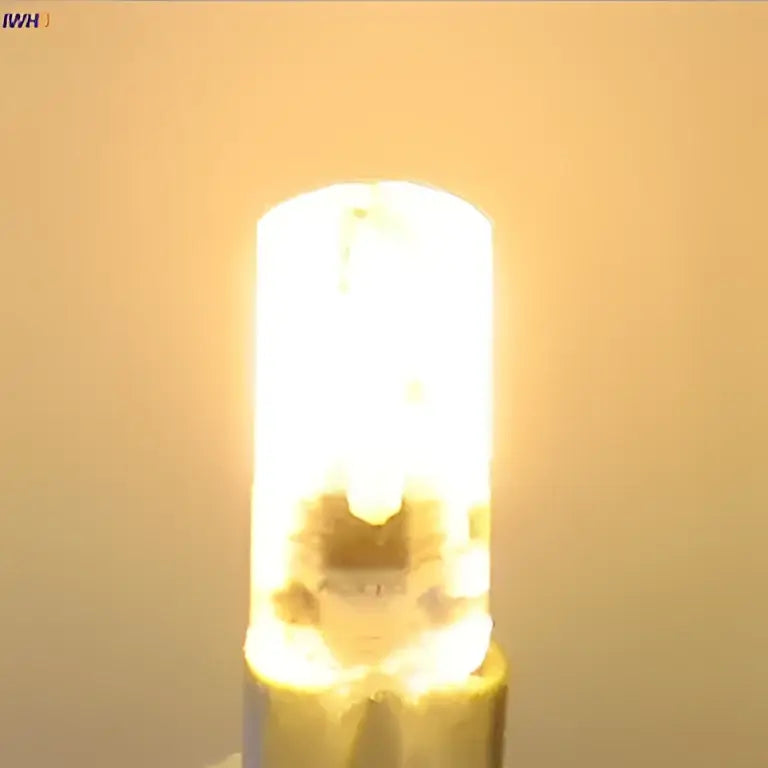 A warm white dimmable decorbites led bulb with a cylindrical glass body and metallic base for living room lighting