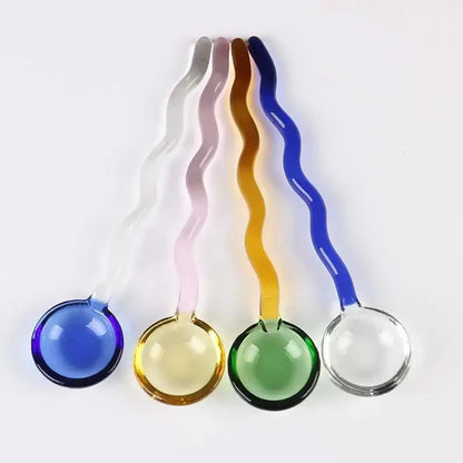 Set of five wavy colorful glass spoon coffee stirring rods with translucent round bowls in blue yellow green pink and clear