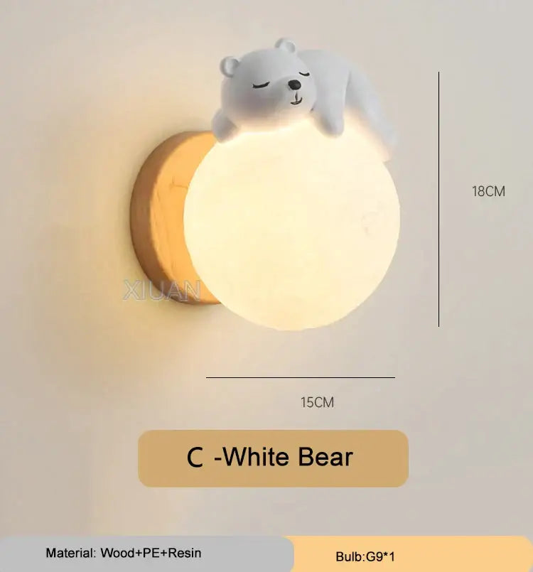 A soft white spherical wall lamp with a cute sleeping bear figurine in a whimsical bear wall lamp for kids bedroom