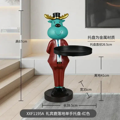 Turquoise reindeer tray ornament dressed in red suit and black top hat holding round metal deer landing tray ornament